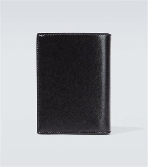 Tiny Cassandre leather passport holder in black 